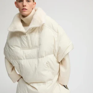 Technical fabric down cape with mink fur stand collar and lining.